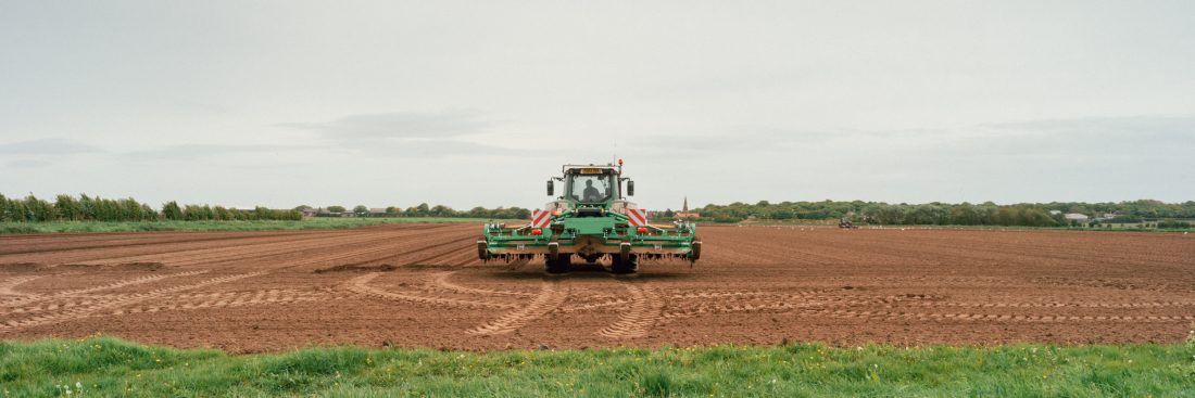 Tractor ploughing a field print