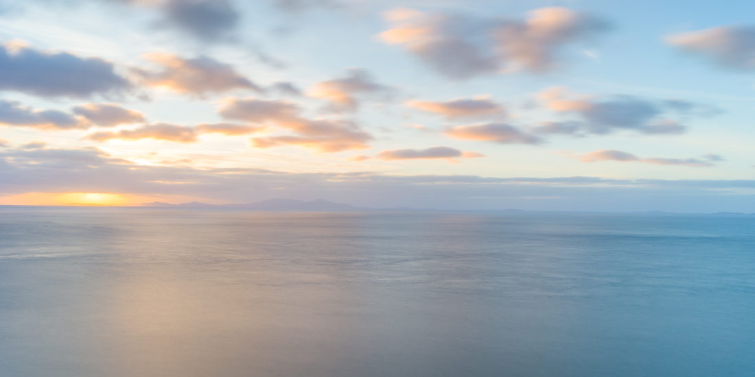 Sunset behind Neist Point Lighthouse and The Outer Hebrides